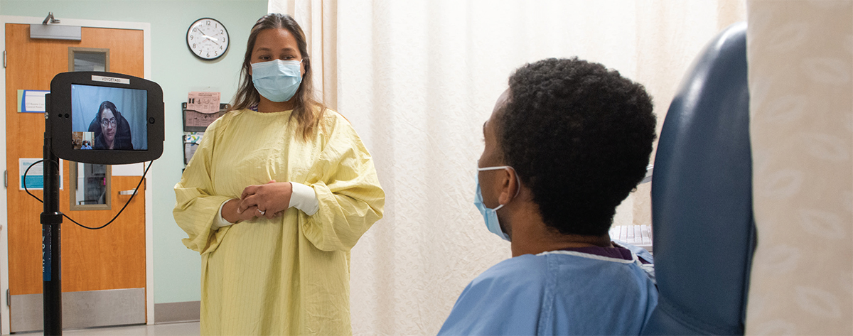A patient discussing his health situation with a medically trained interpreter in his native language.